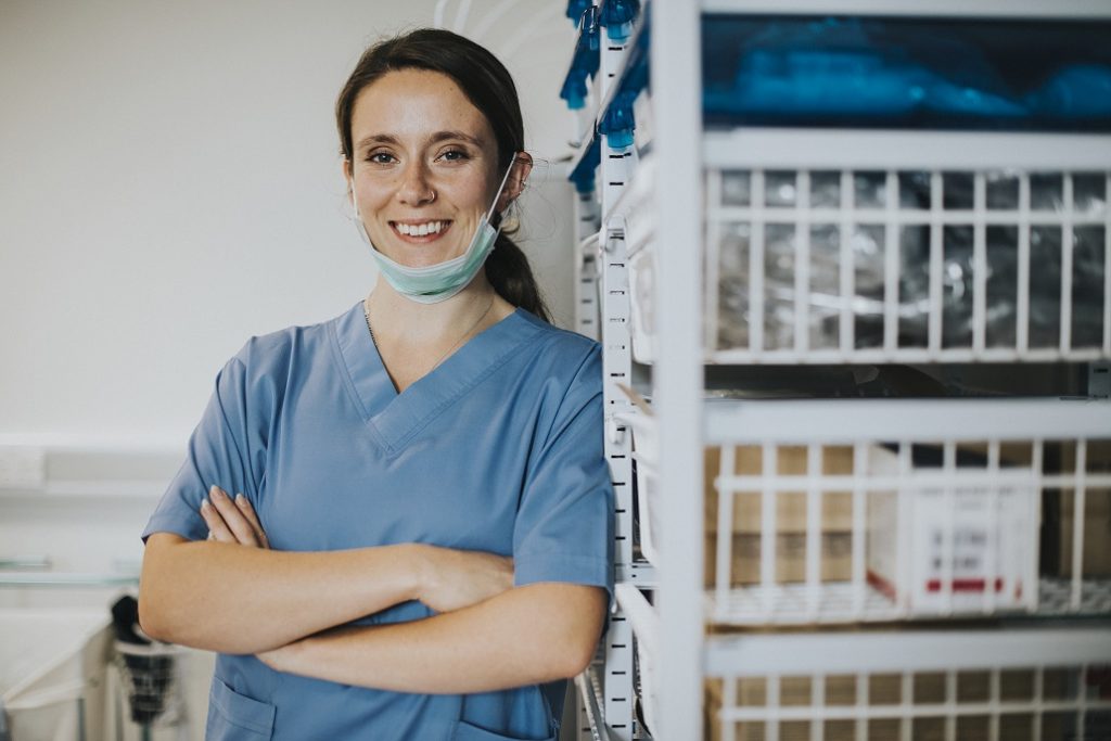 Happy nurse in a medical supplies room