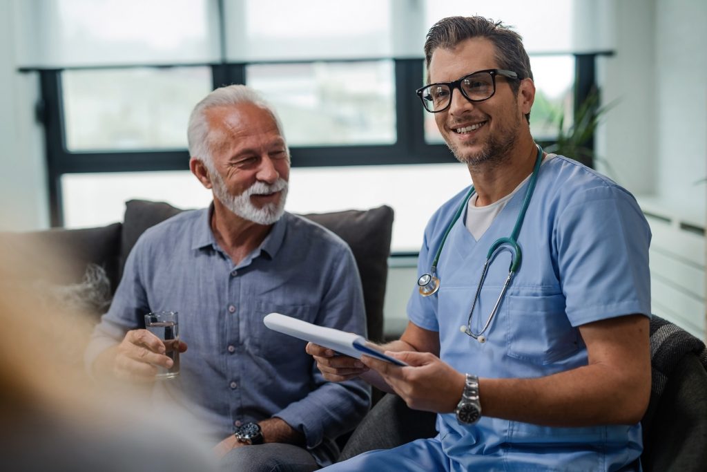 Happy mid adult healthcare worker in a home visit.